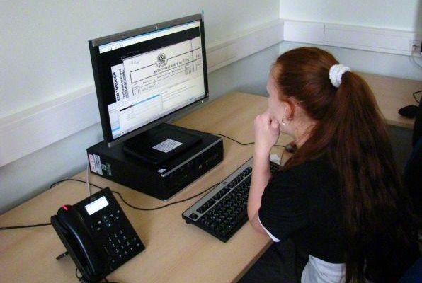 A young woman indexes on her computer