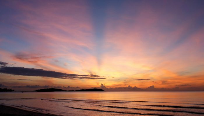 The sun rises over the pacific ocean