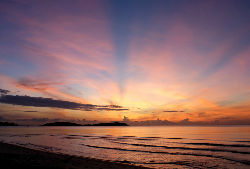 The sun rises over the pacific ocean