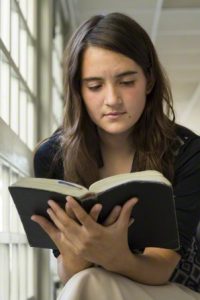 Girl reading and studying the scriptures