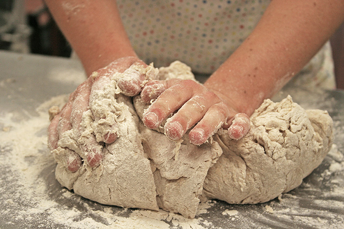 A Woman Kneads Bread