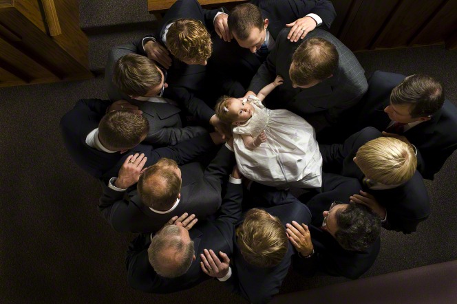 Members of the Church exercise the power of the priesthood as they give a baby blessing. 