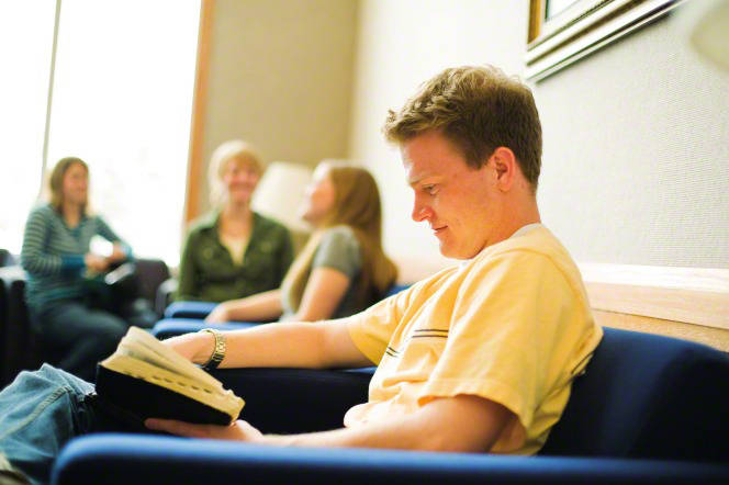 A young man studying parables in the bible