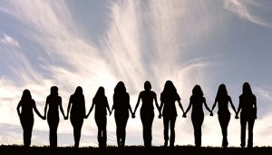 Silhouette of a line of women holding hands