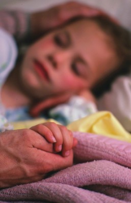 Father watching daughter sleep