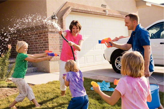 family playing with water