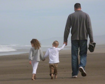 Dad and kids walking on the beach