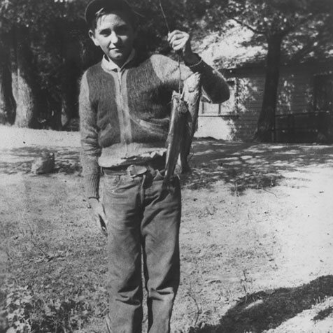 Thomas S. Monson holding up two fish he caught at age 13