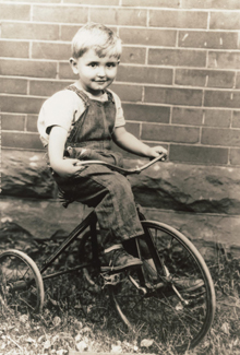 Young Thomas S. Monson riding a tricycle