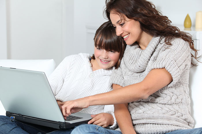 mom and daughter using a laptop computer