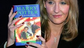JK Rowling holds up a Harry Potter book