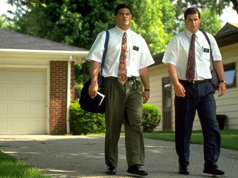 two missionaries walking down the street 