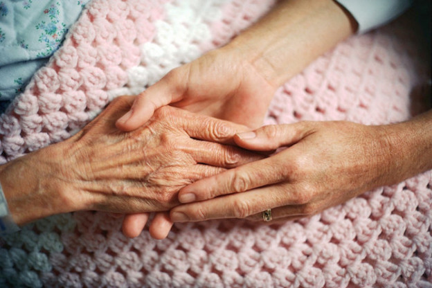 Elderly woman's hands at moment of death