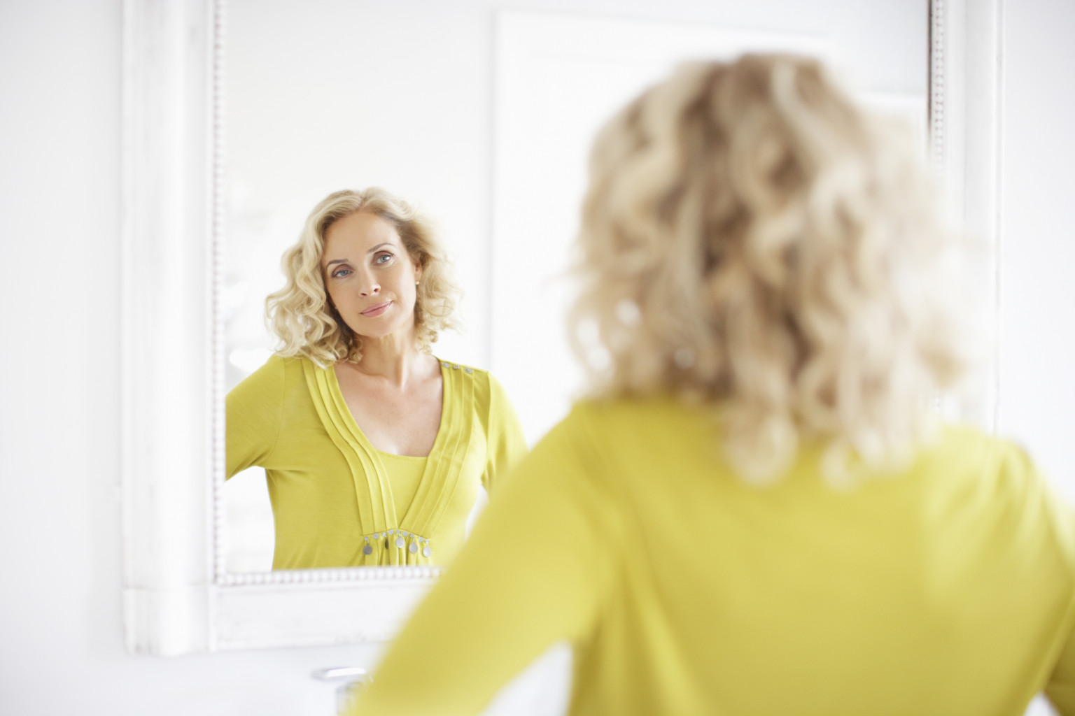Mature woman looking in a mirror