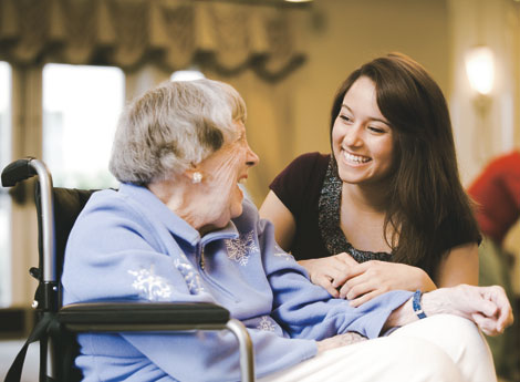 Young woman visiting an elderly woman