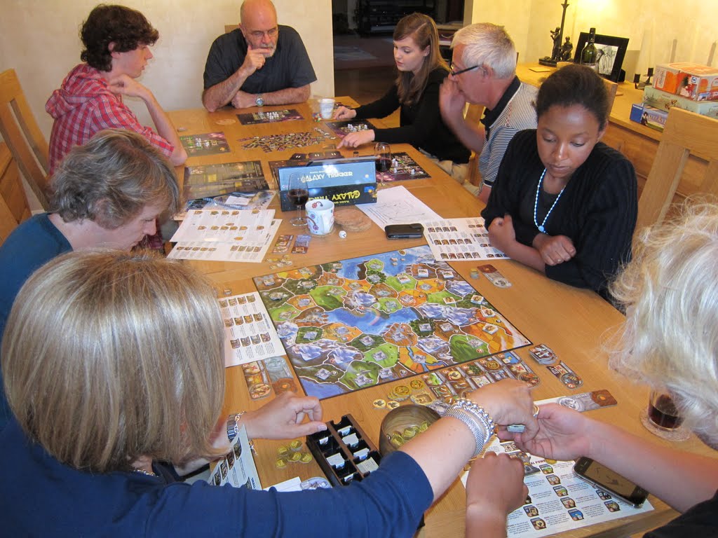 Mormon friends and neighbors playing Board Games around a table