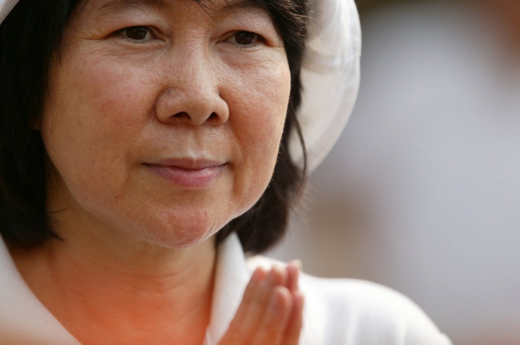 Portrait of middle aged woman praying