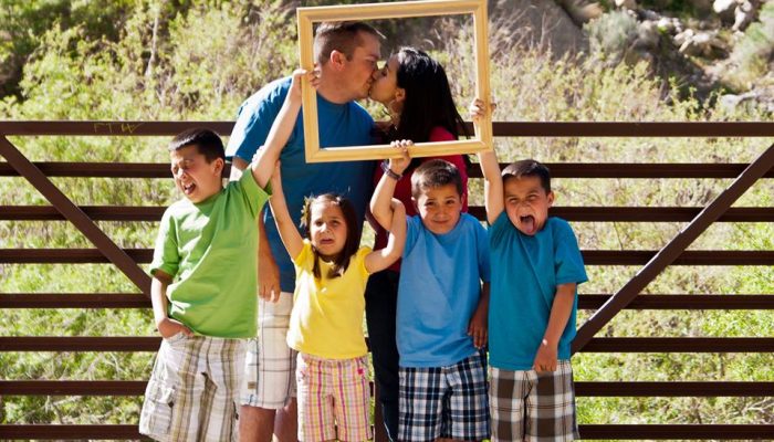 Portrait of married couple and their four young children