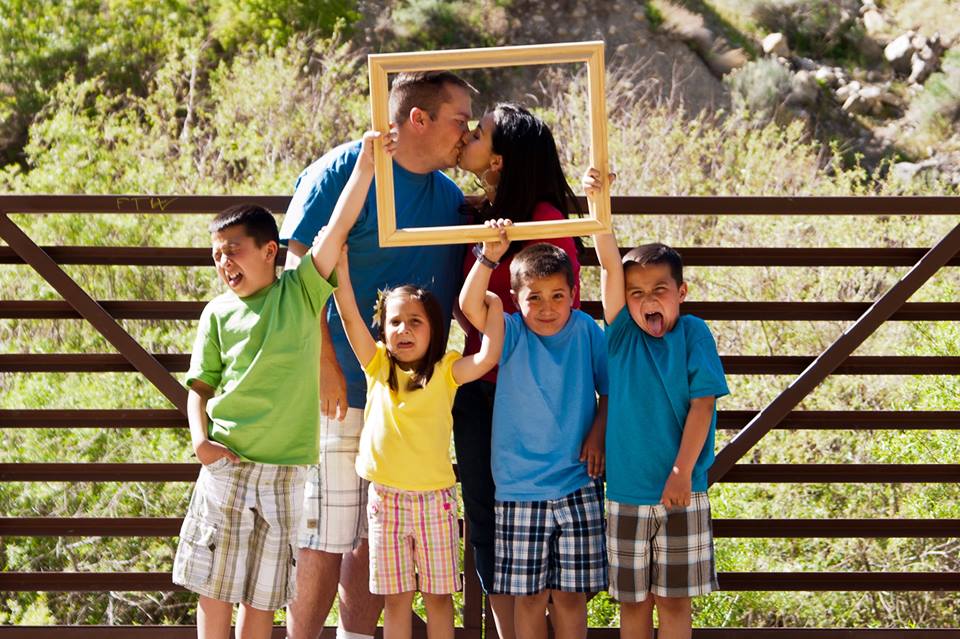 Portrait of married couple and their four young children