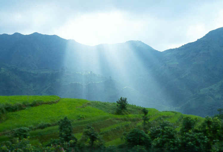 Sunrays over green mountain scape