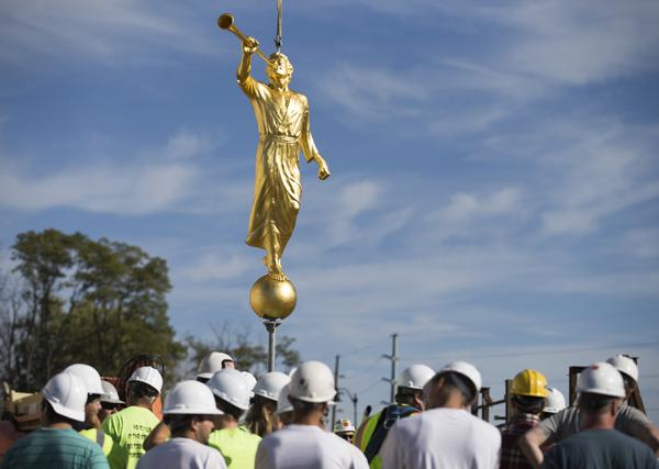 Workers hoisting up the Provo City Center Temple Moroni Statue