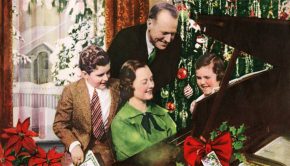 Family gathered around piano singing Christmas songs