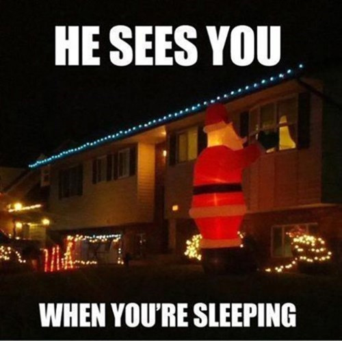 Giant inflatable Santa looking in a bedroom window