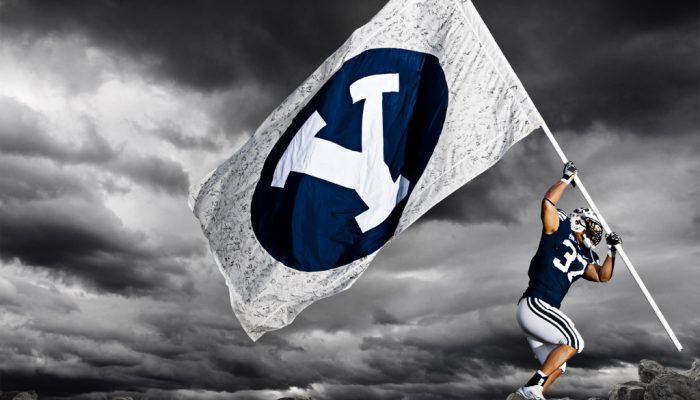 BYU football player raising flag