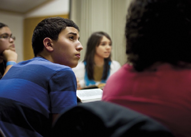 Boy humbly pondering a scriptural lesson