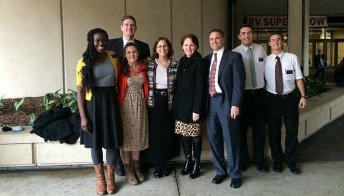 missionaries passing out Book of Mormons