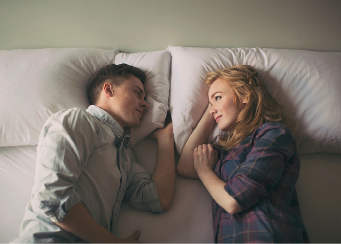 Couple talking in bed