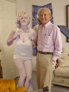 Dr. Roy Nisson, 94, poses with a cutout of Marilyn Monroe, one of his former dental patients. Image via Chris Caldwell. 