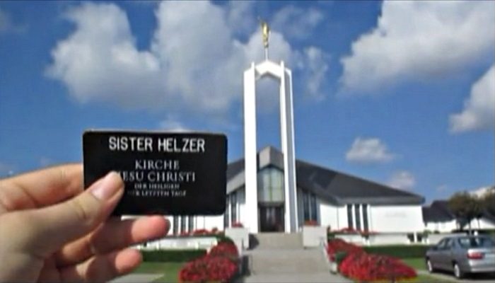 Hand holding up missionary name tag