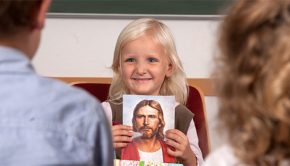 Child shows a picture of Jesus