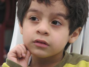 Young boy representing a man with a young face in an interview.