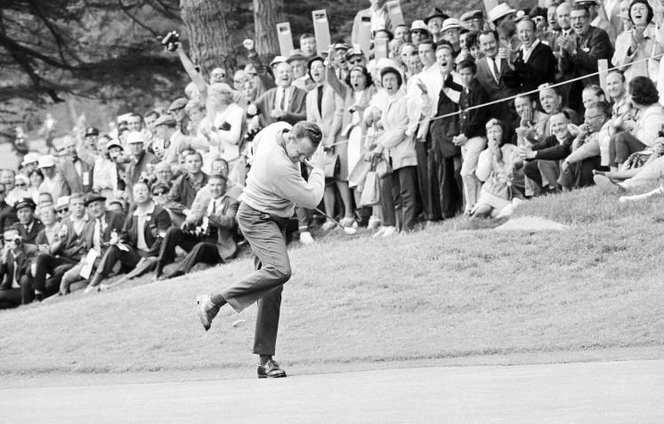 Billy Casper celebrates after sinking a 25-foot putt during the 1966 U.S. Open playoff with Arnold Palmer. Image via TampaBay.com. 