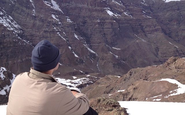 Man sitting in mountains contemplating