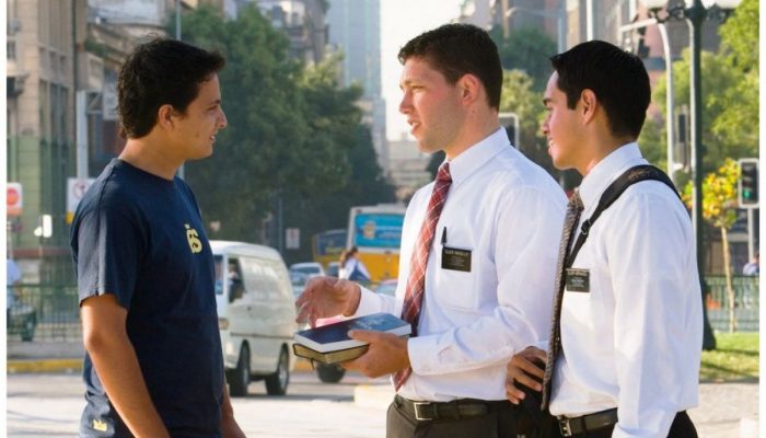 Two male Mormon missionaries talking with a young man on the street