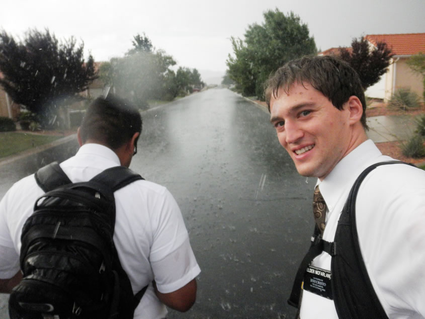 Two Lds missionaries getting wet in the rain