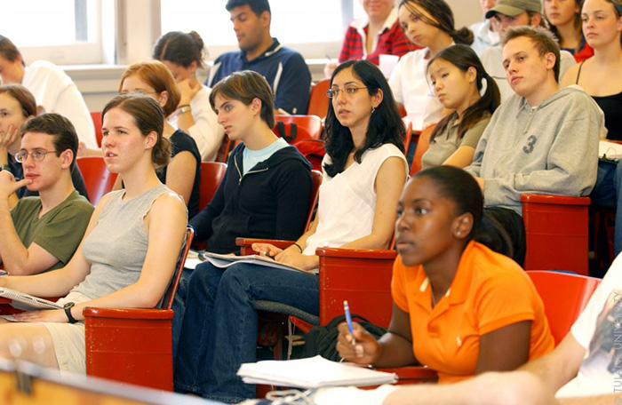 College students sitting in a classroom listening to a teacher