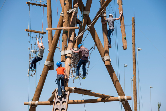 people climbing up the different challenges at the BYU-Idaho ropes course