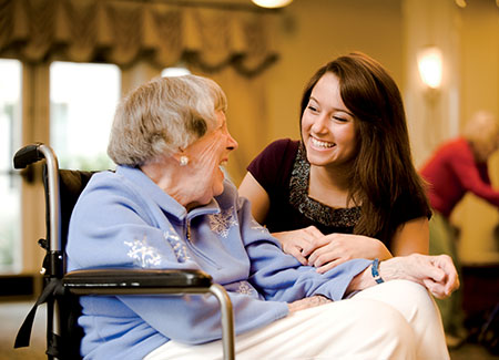 young woman with old woman in wheel chair