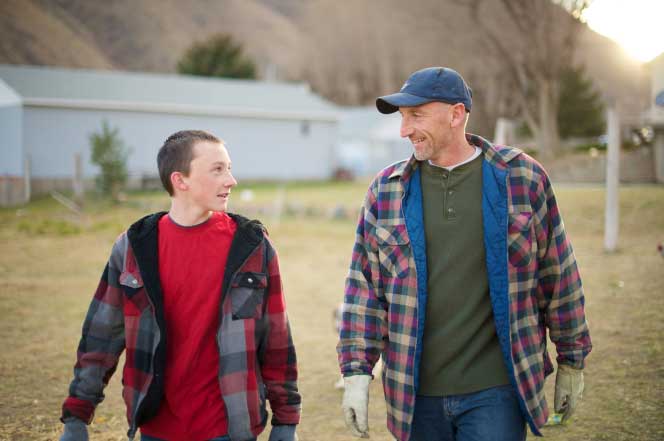 Father and son work on Farm