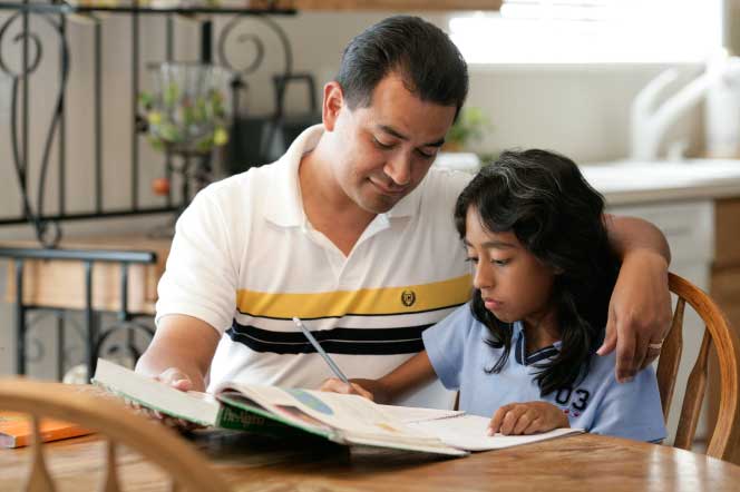 Dad helps daughter with homework