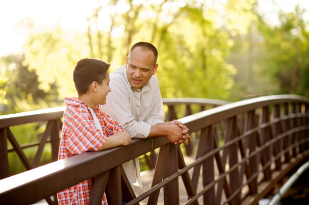 Father and son talk on bridge