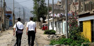 Two missionaries walking in a 3rd world street