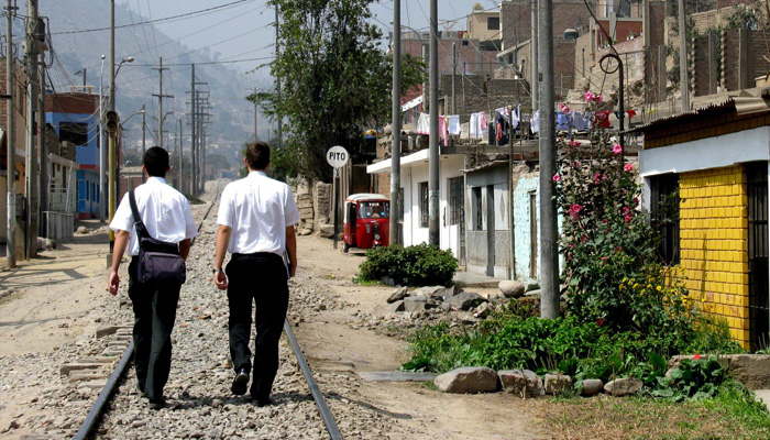 Two missionaries walking in a 3rd world street