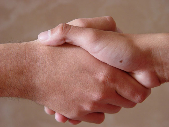 Parent shaking hands with a babysitter