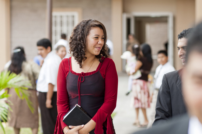 A woman attends sacrament meeting