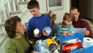 Family of 4 putting together emergency kits at their dinner table. 